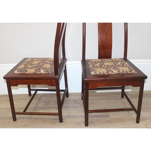 112 - A set of 10 (8 + 2 carvers) Chinese hardwood dining chairs with later animal fabric seats, each appr... 