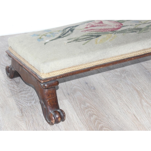 115 - A long low footstool with tapestry top and paw feet and 2 other vintage footstools, the largest appr... 