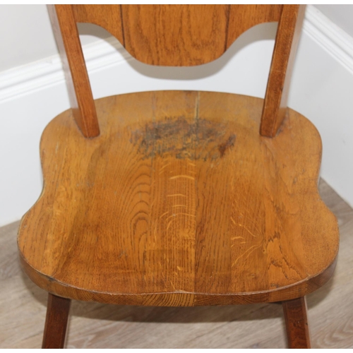 118 - A vintage light oak side chair with carved heraldic lion back, approx 100cm tall