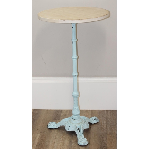 129 - A circular wooden topped Victorian style poseur bar or bistro table on ornate cast iron base, the ba... 