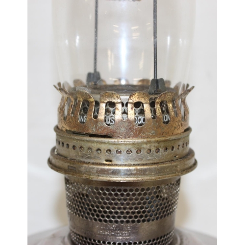 247 - 4 oil lamps to include an Aladdin 23 oil lamp with glass chimney and 3 smaller lamps, largest approx... 