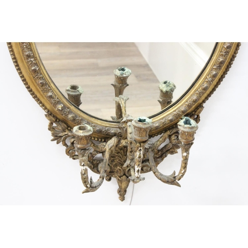 388 - A 19th century gilt framed oval girandole wall mirror, the mirror made from giltwood and gesso with ... 