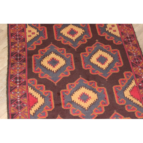 218 - A vintage Persian geometric designed rug with red ground and blue and cream gul design, approx 180cm... 