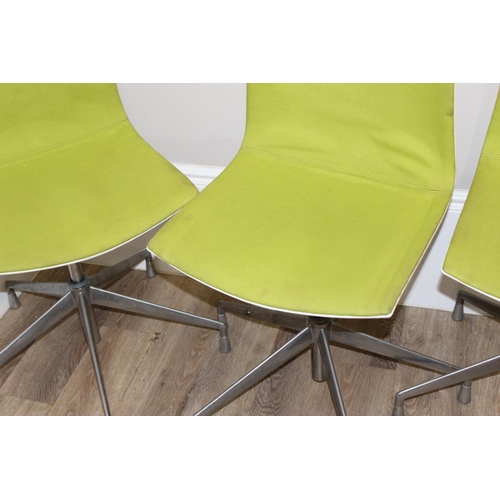 133 - A set of 4 Italian made retro style swivel chairs with metal base and green fabric upholstery, made ... 