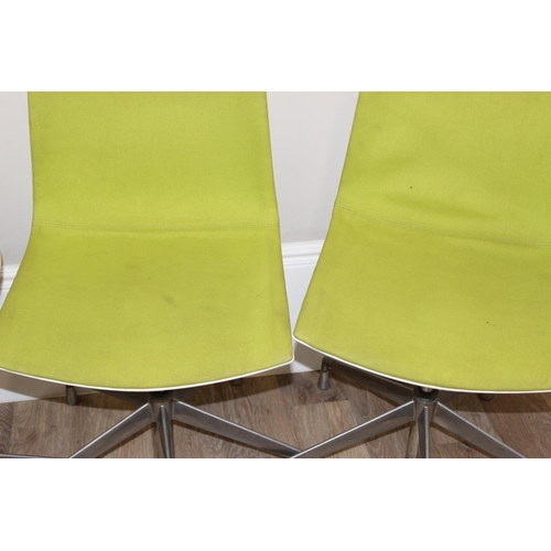 133 - A set of 4 Italian made retro style swivel chairs with metal base and green fabric upholstery, made ... 