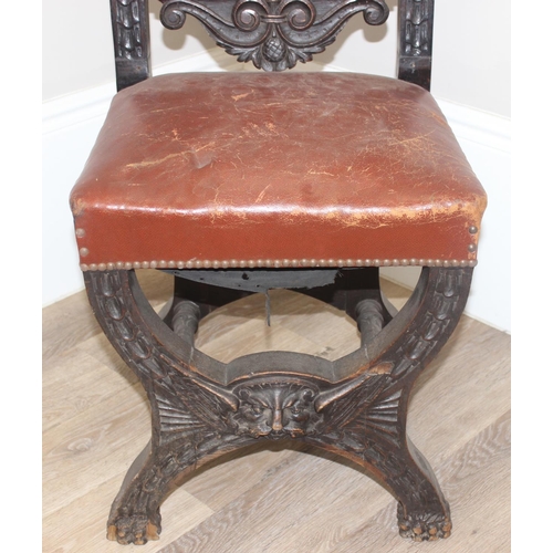 135 - A 17th century style carved oak chair with leather seat and back, the frame profusely carved with va... 