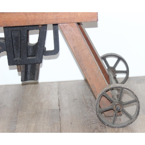 142 - A vintage bottle corker or capper mounted on wooden bench, the mechanism marked for Loftus of London... 