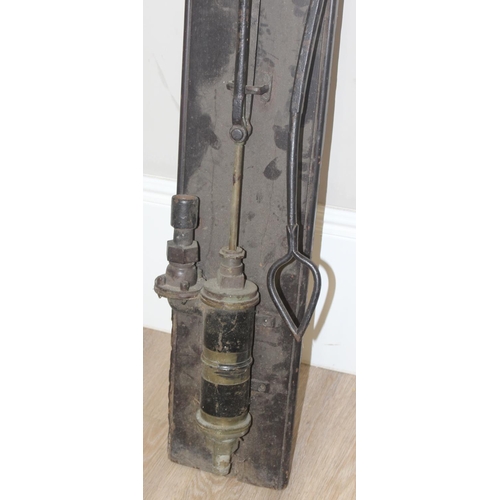 144 - A vintage wall mounted iron garden water pump on wooden plaque, approx 122cm tall