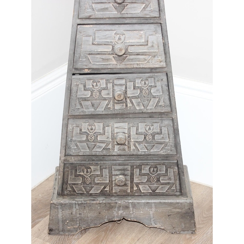 146 - An unusual 7 drawer pyramid shaped chest of drawers with Aztec style carved details, approx 150cm ta... 