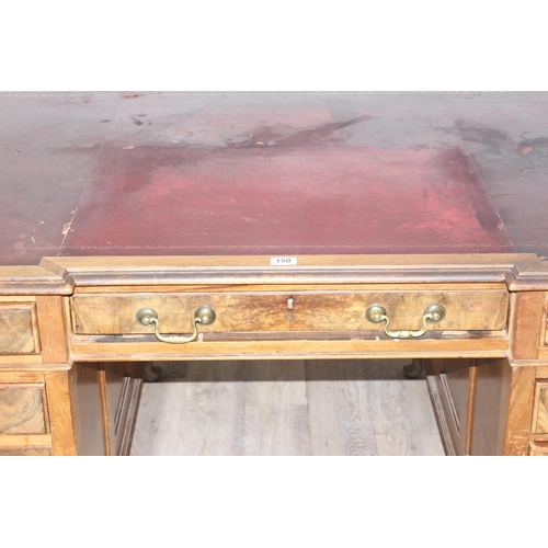 150 - An early 20th century Walnut desk by Hamptons of London, a walnut veneered 9 drawer desk with Georgi... 