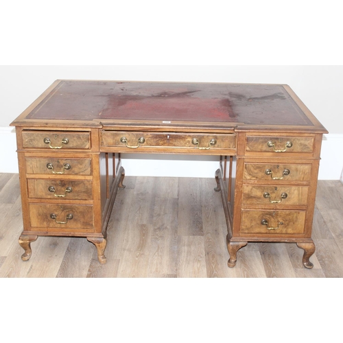 150 - An early 20th century Walnut desk by Hamptons of London, a walnut veneered 9 drawer desk with Georgi... 