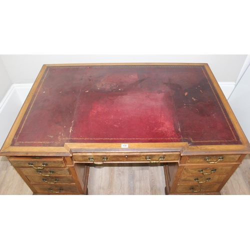 150 - An early 20th century Walnut desk by Hamptons of London, a walnut veneered 9 drawer desk with Georgi... 