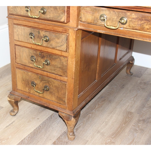 150 - An early 20th century Walnut desk by Hamptons of London, a walnut veneered 9 drawer desk with Georgi... 