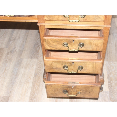 150 - An early 20th century Walnut desk by Hamptons of London, a walnut veneered 9 drawer desk with Georgi... 