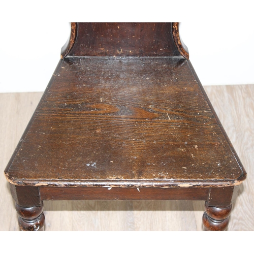 151 - A 19th century stained pine hall chair, approx 85cm tall