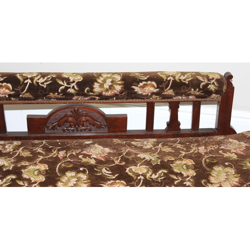 155 - An antique mahogany framed chaises longue with turned legs and carved details and floral patterned u... 