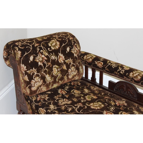 155 - An antique mahogany framed chaises longue with turned legs and carved details and floral patterned u... 