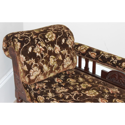 155 - An antique mahogany framed chaises longue with turned legs and carved details and floral patterned u... 