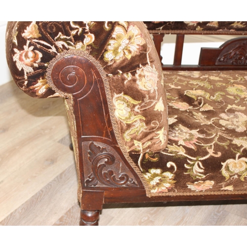 155 - An antique mahogany framed chaises longue with turned legs and carved details and floral patterned u... 