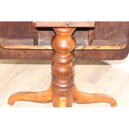 156 - A 19th century mahogany tilt topped table with turned support and tripod base, approx 82cm wide x 67... 