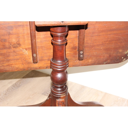 158 - A 19th century mahogany tilt topped table with turned support and tripod base, approx 74cm wide x 70... 