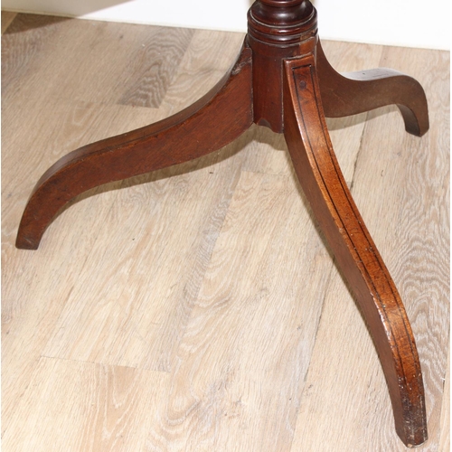 158 - A 19th century mahogany tilt topped table with turned support and tripod base, approx 74cm wide x 70... 