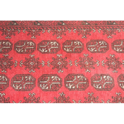 217 - Small hand woven red ground Bokhara style rug by Tariq Sultan & Co, approx 120cm x 82cm