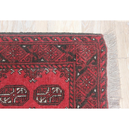 217 - Small hand woven red ground Bokhara style rug by Tariq Sultan & Co, approx 120cm x 82cm