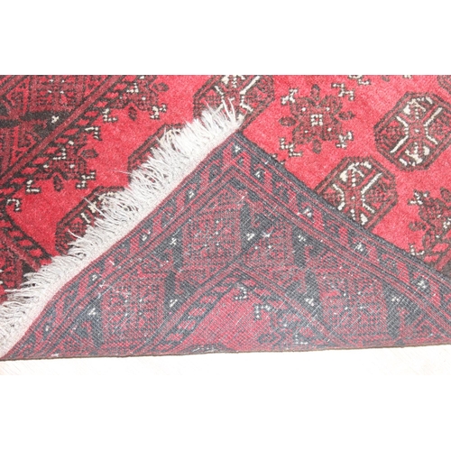 217 - Small hand woven red ground Bokhara style rug by Tariq Sultan & Co, approx 120cm x 82cm