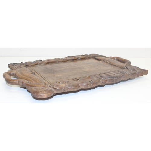 282 - An early 20th century Oriental carved wooden tray decorated with dragons, approx 46cm x 30cm