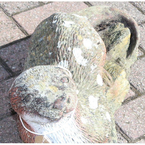 303 - A painted concrete garden ornament of an otter, approx 58cm long