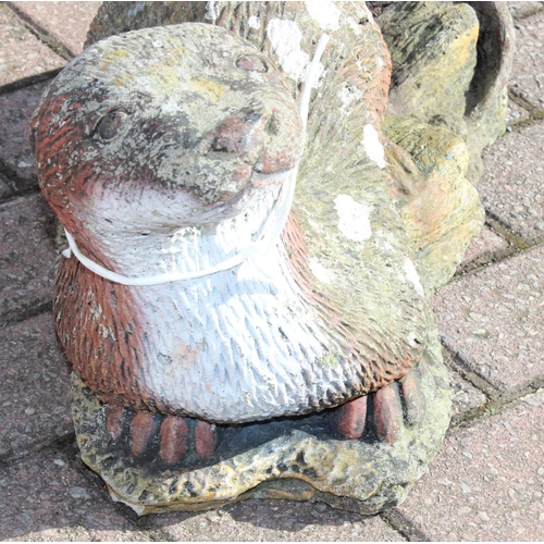 303 - A painted concrete garden ornament of an otter, approx 58cm long