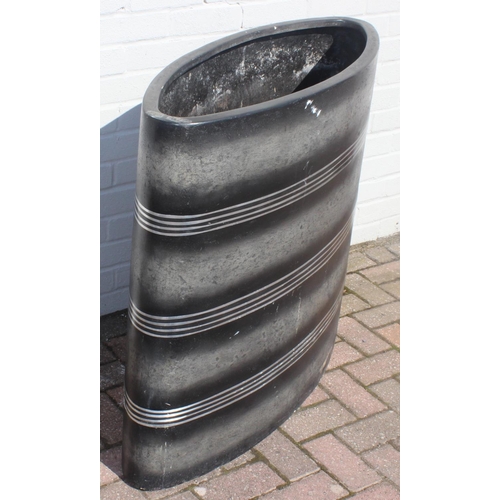 307 - A large elliptical shaped garden planter with black finish and banded design, approx 101cm wide x 85... 