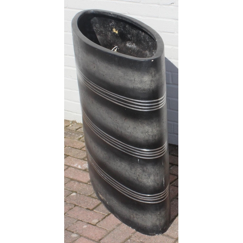 307 - A large elliptical shaped garden planter with black finish and banded design, approx 101cm wide x 85... 