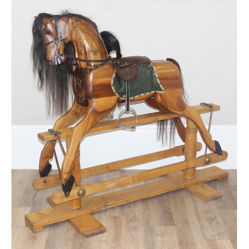 630 - A large vintage hand carved wooden rocking horse with leather saddle and horse hair mane and tail, s... 