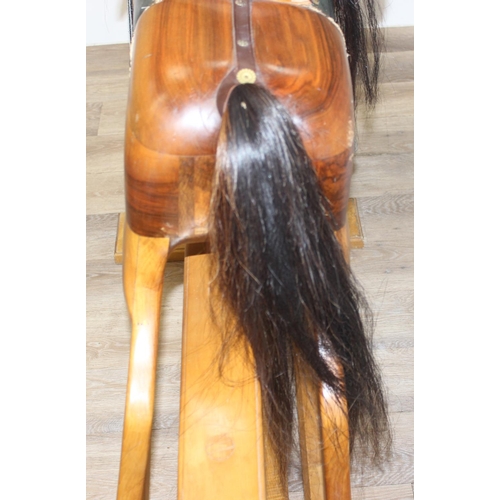 630 - A large vintage hand carved wooden rocking horse with leather saddle and horse hair mane and tail, s... 