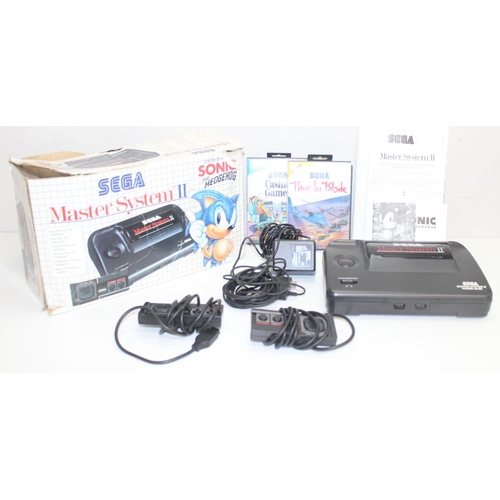 752 - A vintage Sega Master System II games console in original box to include games Thunder Blade and Cas... 