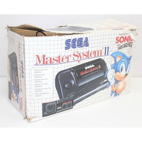 752 - A vintage Sega Master System II games console in original box to include games Thunder Blade and Cas... 