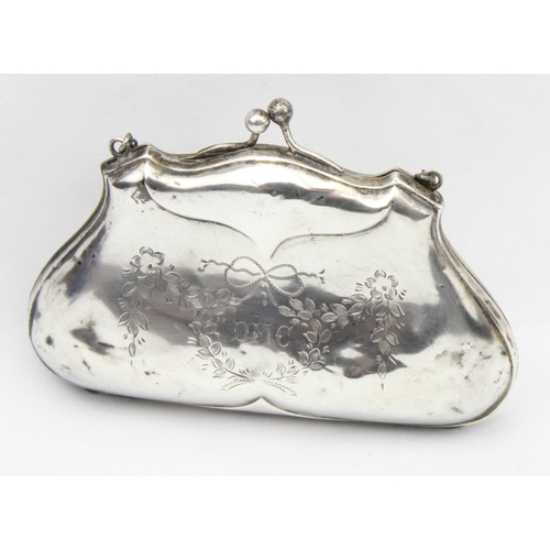 1013 - An antique silver evening bag or purse with engraved floral decoration and canvas line concertina in... 