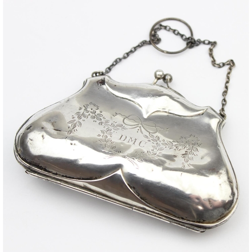 1013 - An antique silver evening bag or purse with engraved floral decoration and canvas line concertina in... 