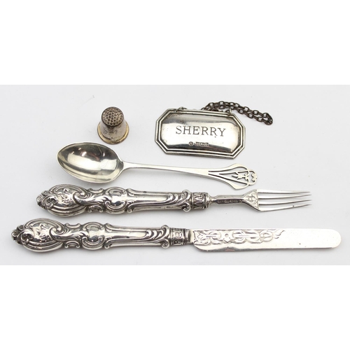 1038 - A boxed silver thimble, a Victorian silver fruit knife and fork with silver blades and tines, an Art... 