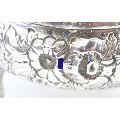 1048 - A pair of early Victorian cast silver salts with floral and lion head decoration, with blue glass li... 