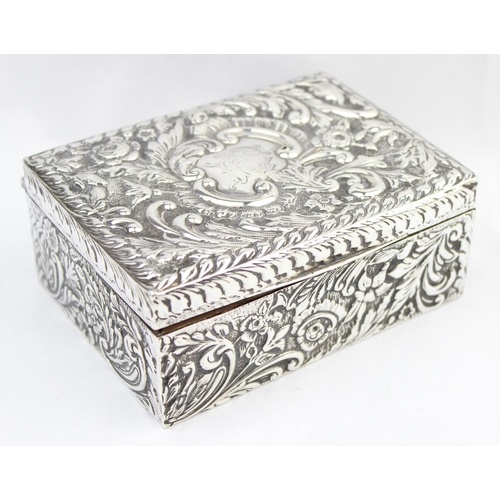 1050 - A highly decorative Chester silver cigar or cigarette box with embossed floral scrolls, marked for C... 