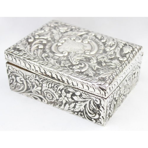 1050 - A highly decorative Chester silver cigar or cigarette box with embossed floral scrolls, marked for C... 