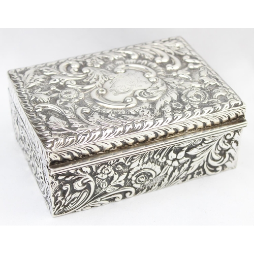 1050 - A highly decorative Chester silver cigar or cigarette box with embossed floral scrolls, marked for C... 