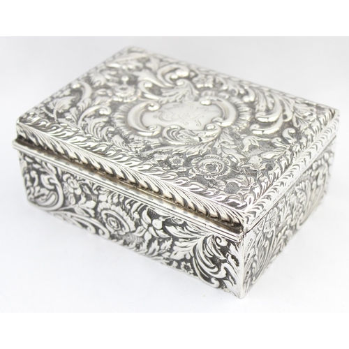 1050 - A highly decorative Chester silver cigar or cigarette box with embossed floral scrolls, marked for C... 