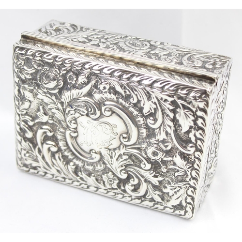 1050 - A highly decorative Chester silver cigar or cigarette box with embossed floral scrolls, marked for C... 