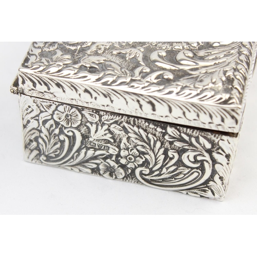 1050 - A highly decorative Chester silver cigar or cigarette box with embossed floral scrolls, marked for C... 