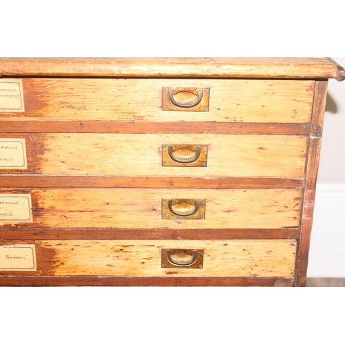 178 - A vintage stained pine plan chest, 8 drawers with campaign style recessed brass handles, approx 110c... 