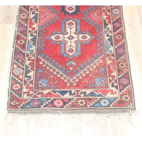 219 - A vintage red ground runner rug, possibly Turkish, approx 295cm x 78cm